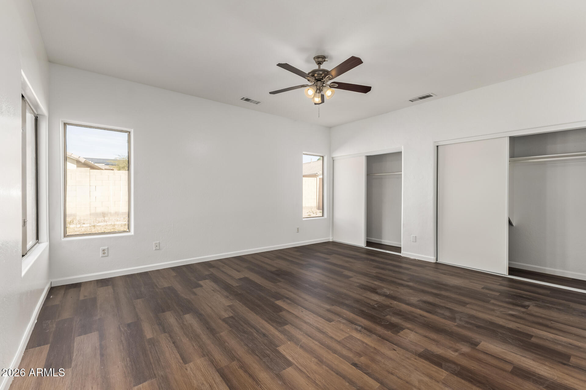 8320 West Apache Street Tolleson, AZ 85353 - Photo 13 of 31 a view of an empty room with wooden floor and a window