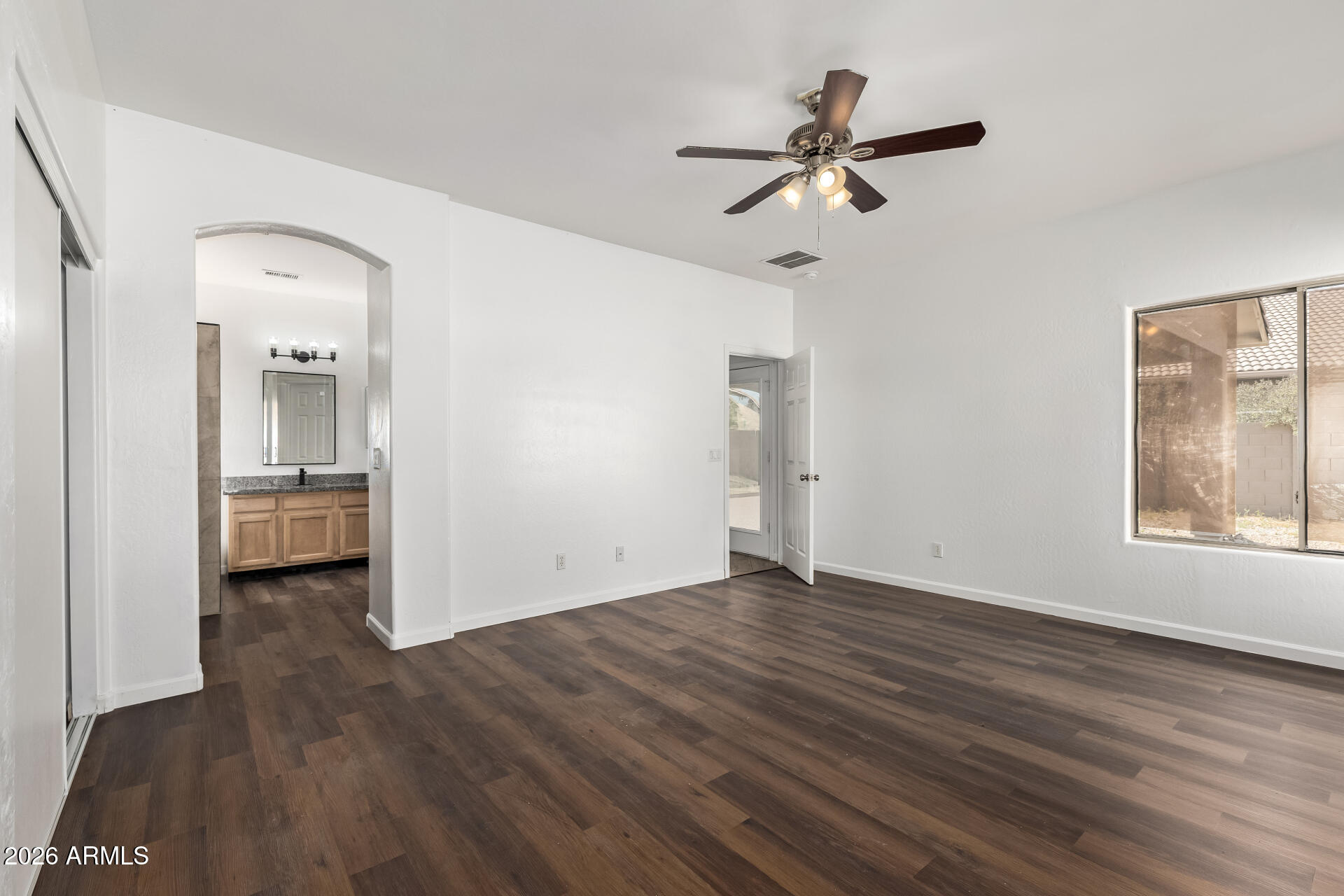 8320 West Apache Street Tolleson, AZ 85353 - Photo 14 of 31 wooden floor in an empty room with a window