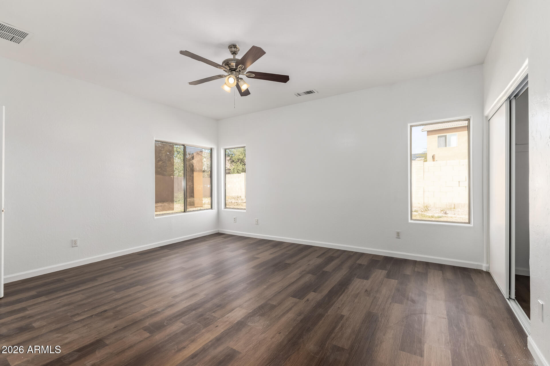 8320 West Apache Street Tolleson, AZ 85353 - Photo 15 of 31 a view of a big room with wooden floor and windows