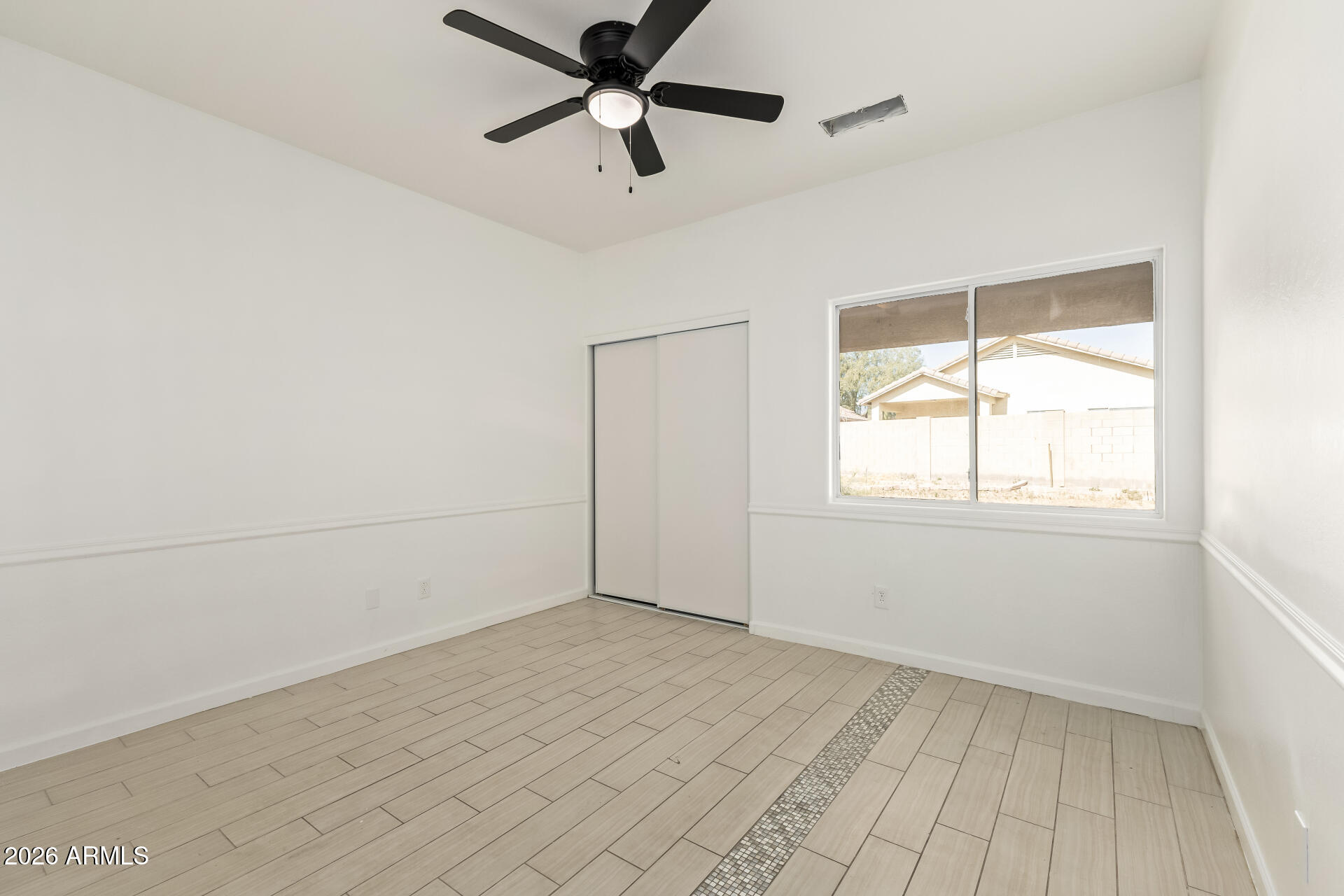 8320 West Apache Street Tolleson, AZ 85353 - Photo 19 of 31 wooden floor in an empty room with a window