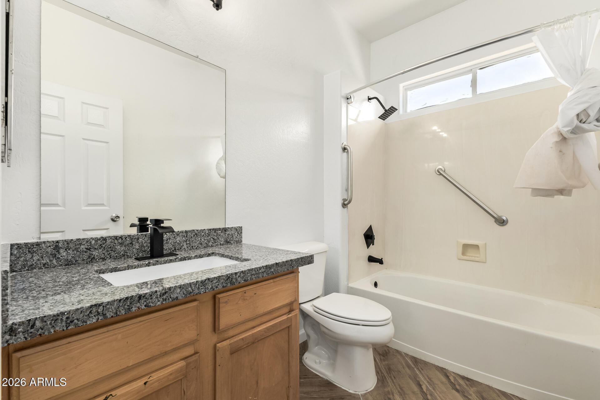 8320 West Apache Street Tolleson, AZ 85353 - Photo 23 of 31 a bathroom with a granite countertop sink toilet and shower