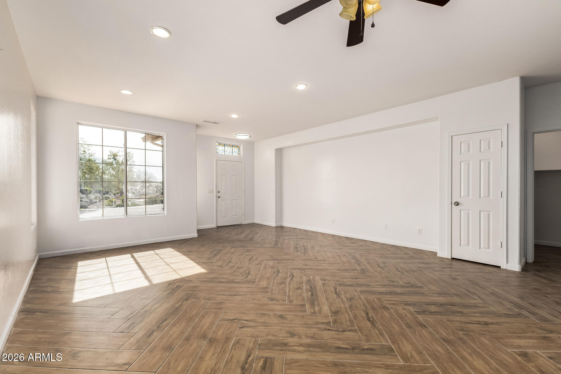 8320 West Apache Street Tolleson, AZ 85353 - Photo 5 of 31 wooden floor in an empty room with a window