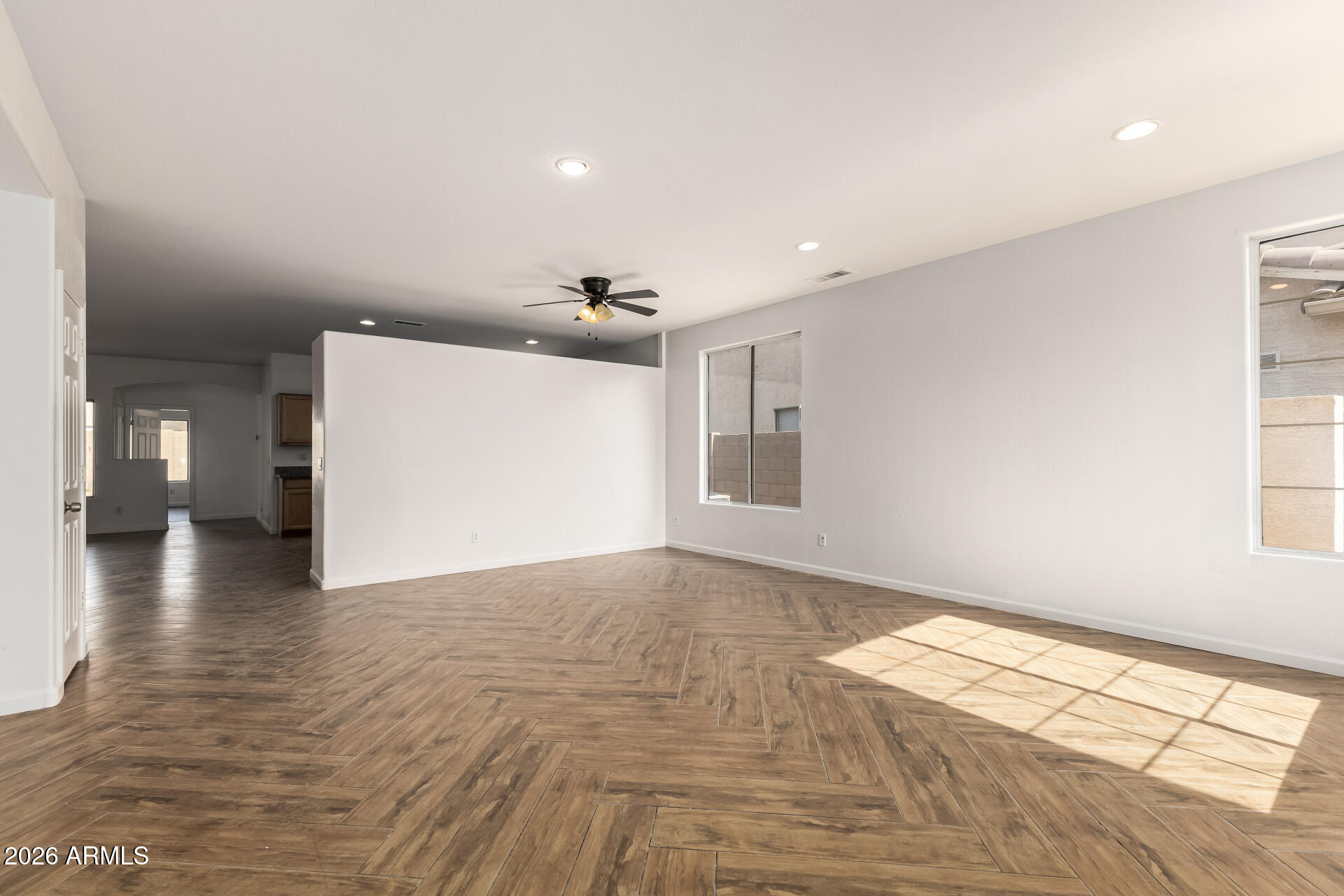 8320 West Apache Street Tolleson, AZ 85353 - Photo 6 of 31 a view of empty room with wooden floor and fan