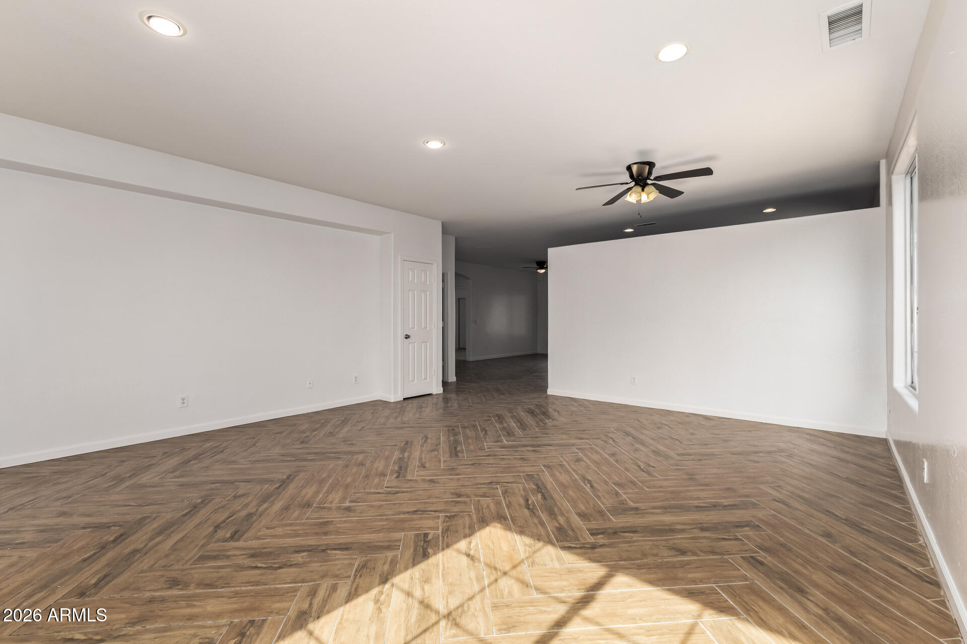 8320 West Apache Street Tolleson, AZ 85353 - Photo 7 of 31 a view of a room with a wooden floor and chandelier