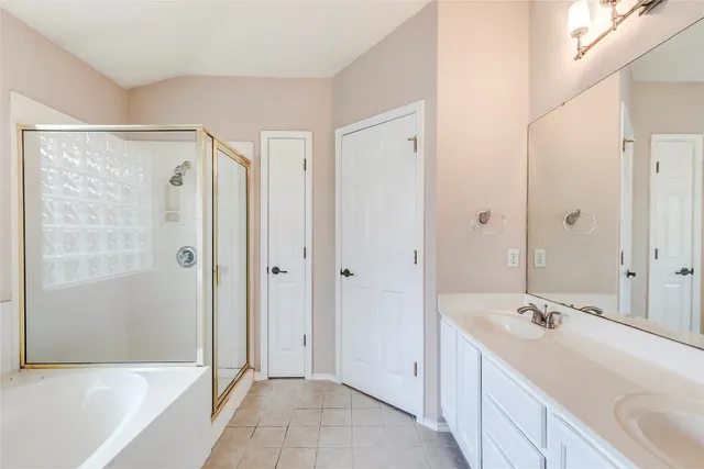 a white bath tub sitting in a bathroom next to a window