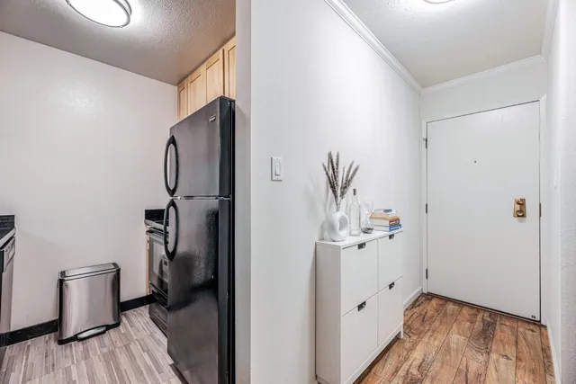 a view of a hallway with wooden floor and closet area