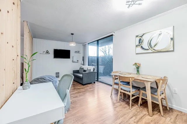 a view of a dining room with furniture window and wooden floor