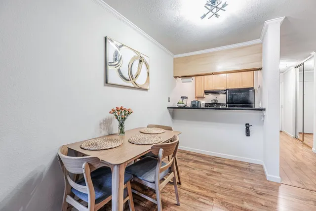 a view of a dining room with furniture and wooden floor