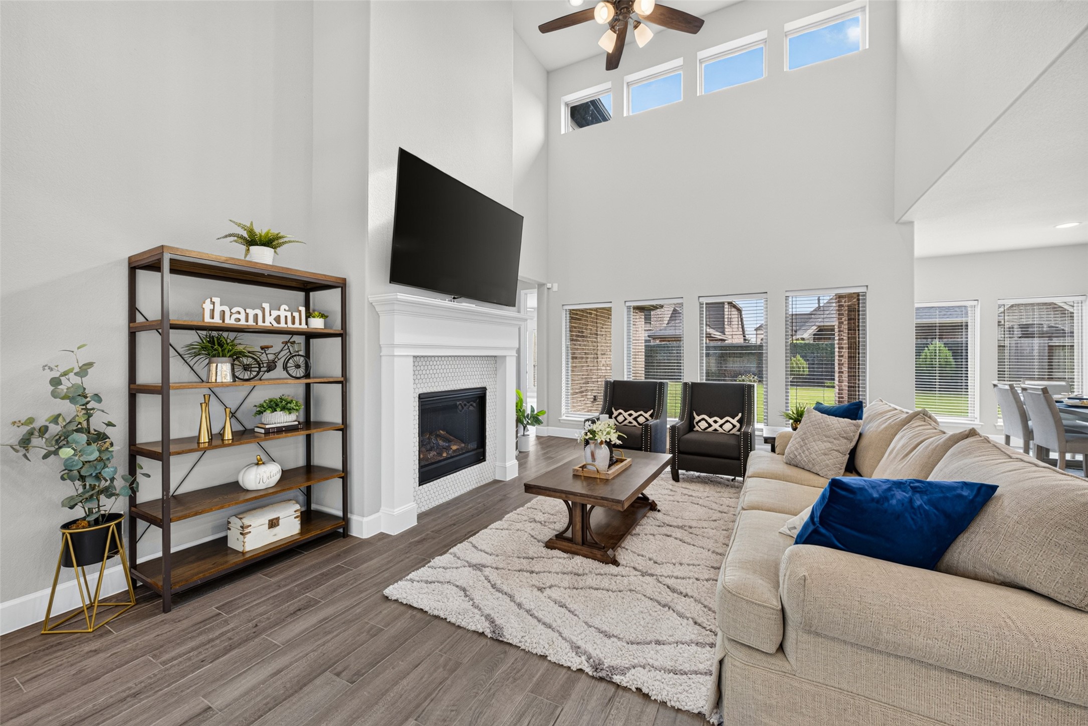 4207 Ana Ridge Lane Fulshear, TX 77441 - Photo 4 of 37 Warm and inviting living room featuring rich wood flooring and generous natural light where family memories are made.