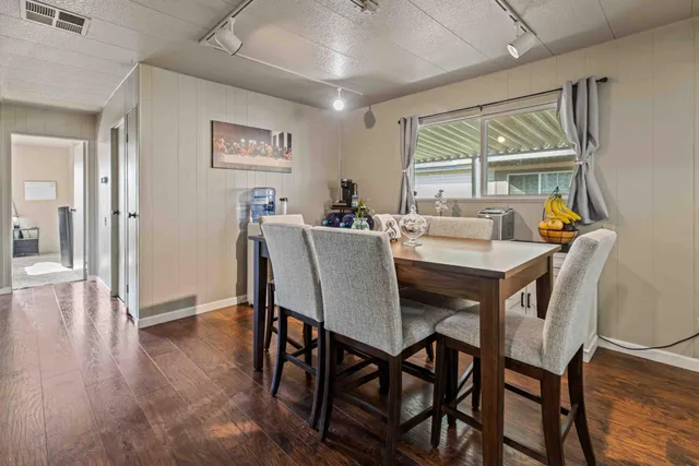 a view of a dining room with furniture window and wooden floor