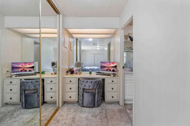 a bathroom with a granite countertop sink mirror vanity and toilet