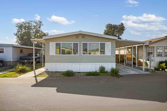a view of a house next to a yard