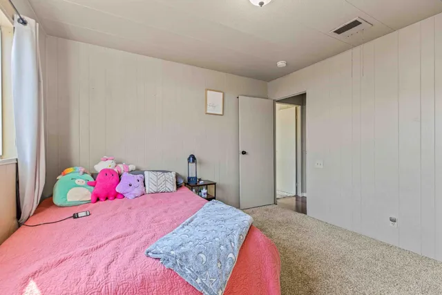 a view of a balcony with wooden floor and fence