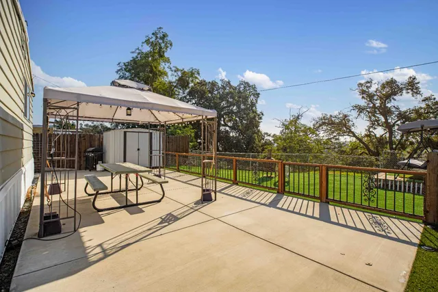 a view of a house with wooden fence