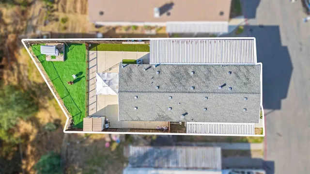 an aerial view of a house with outdoor space