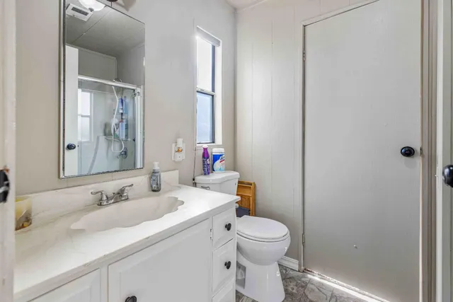 a bathroom with a sink toilet and shower