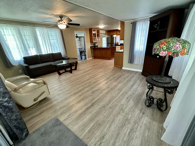 a living room with furniture and a chandelier