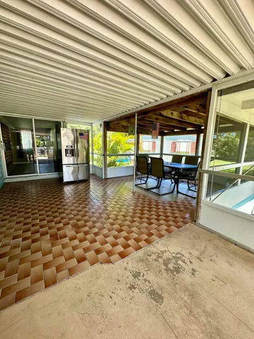 a view of a swimming pool with chairs in patio