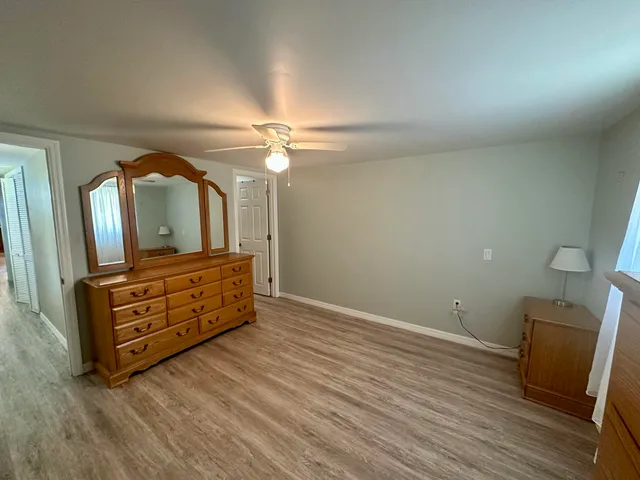 wooden floor in a room with a mirror