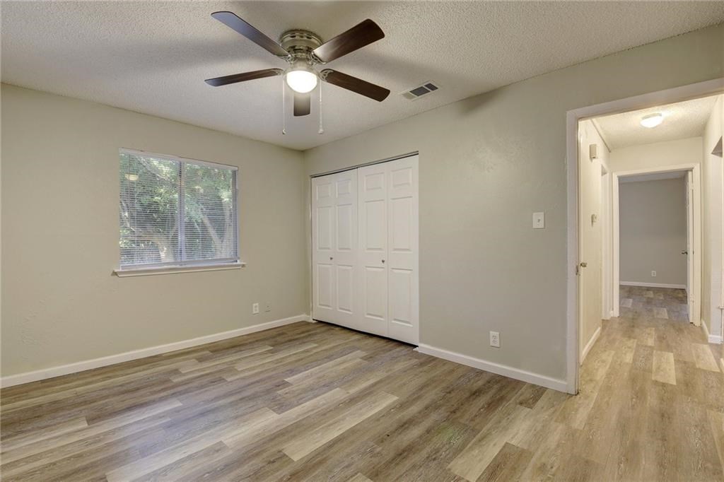2311 Teri Road, Unit B Austin, TX 78744 - Photo 17 of 25 a view of empty room with wooden floor and fan