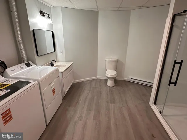a bathroom with a sink a toilet and mirror