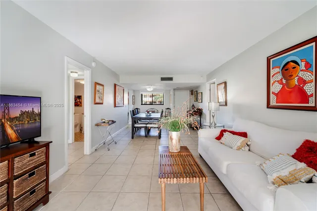 a bedroom with furniture and a flat screen tv