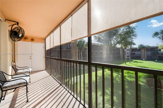 a view of a porch with wooden floor and iron stairs