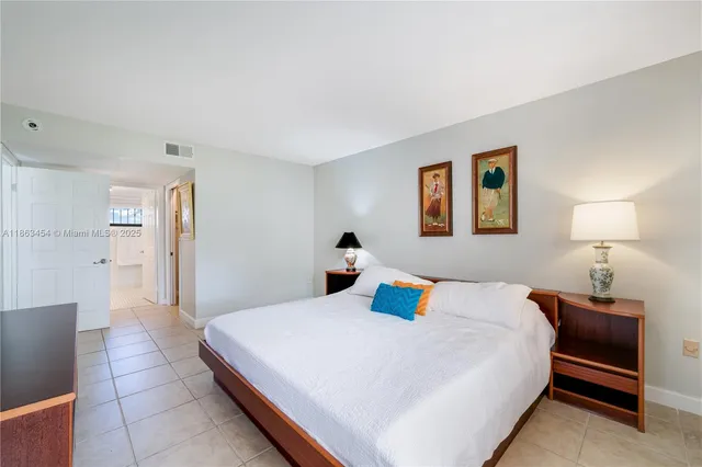 a bedroom with a bed and a lamp