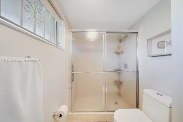a bathroom with a shower and a toilet