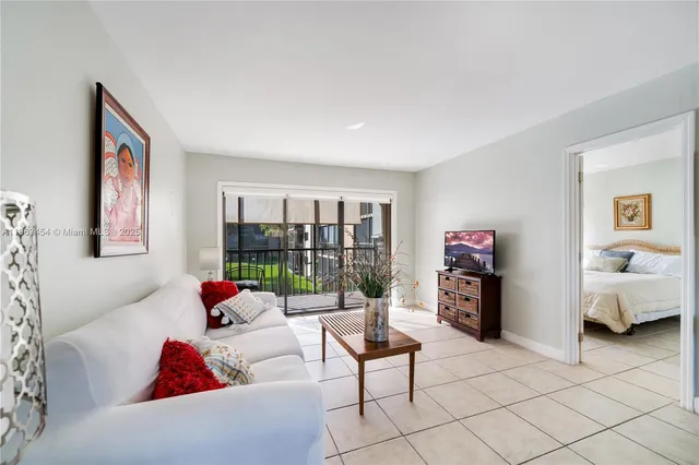 a living room with furniture and a floor to ceiling window