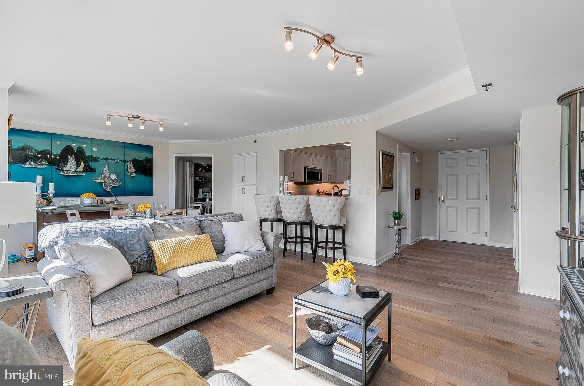 5450 Whitley Park Terrace, Unit 209 Bethesda, MD 20814 - Photo 11 of 29 a living room with furniture and wooden floor