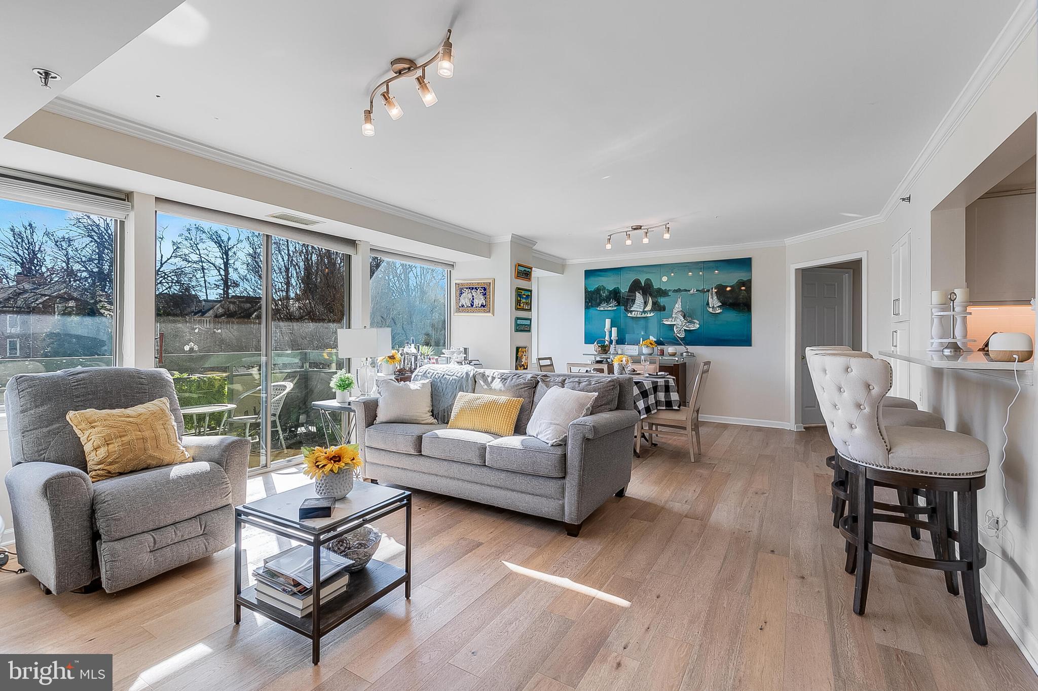 5450 Whitley Park Terrace, Unit 209 Bethesda, MD 20814 - Photo 12 of 29 a living room with furniture and a large window