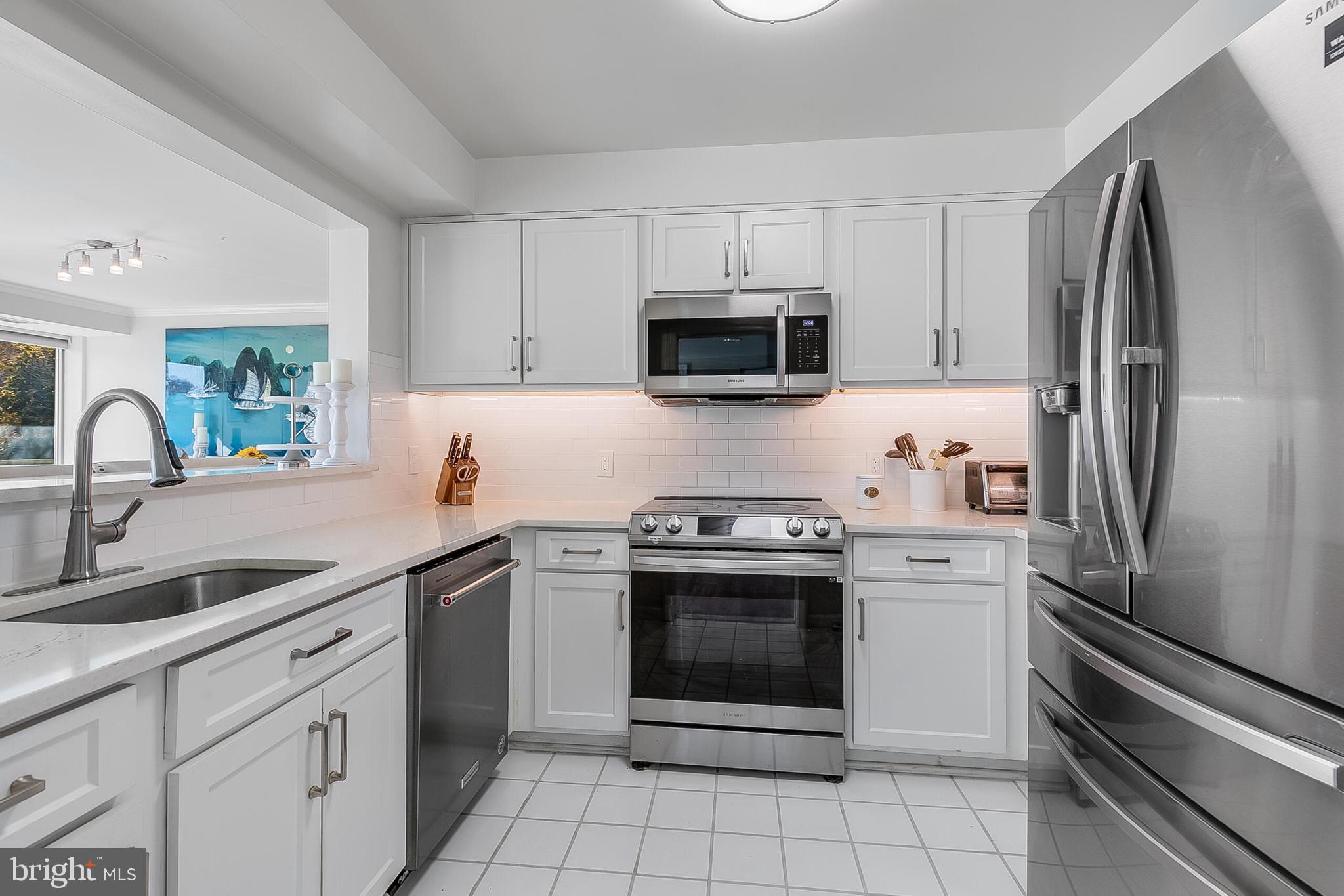 5450 Whitley Park Terrace, Unit 209 Bethesda, MD 20814 - Photo 13 of 29 a kitchen with cabinets stainless steel appliances and a sink