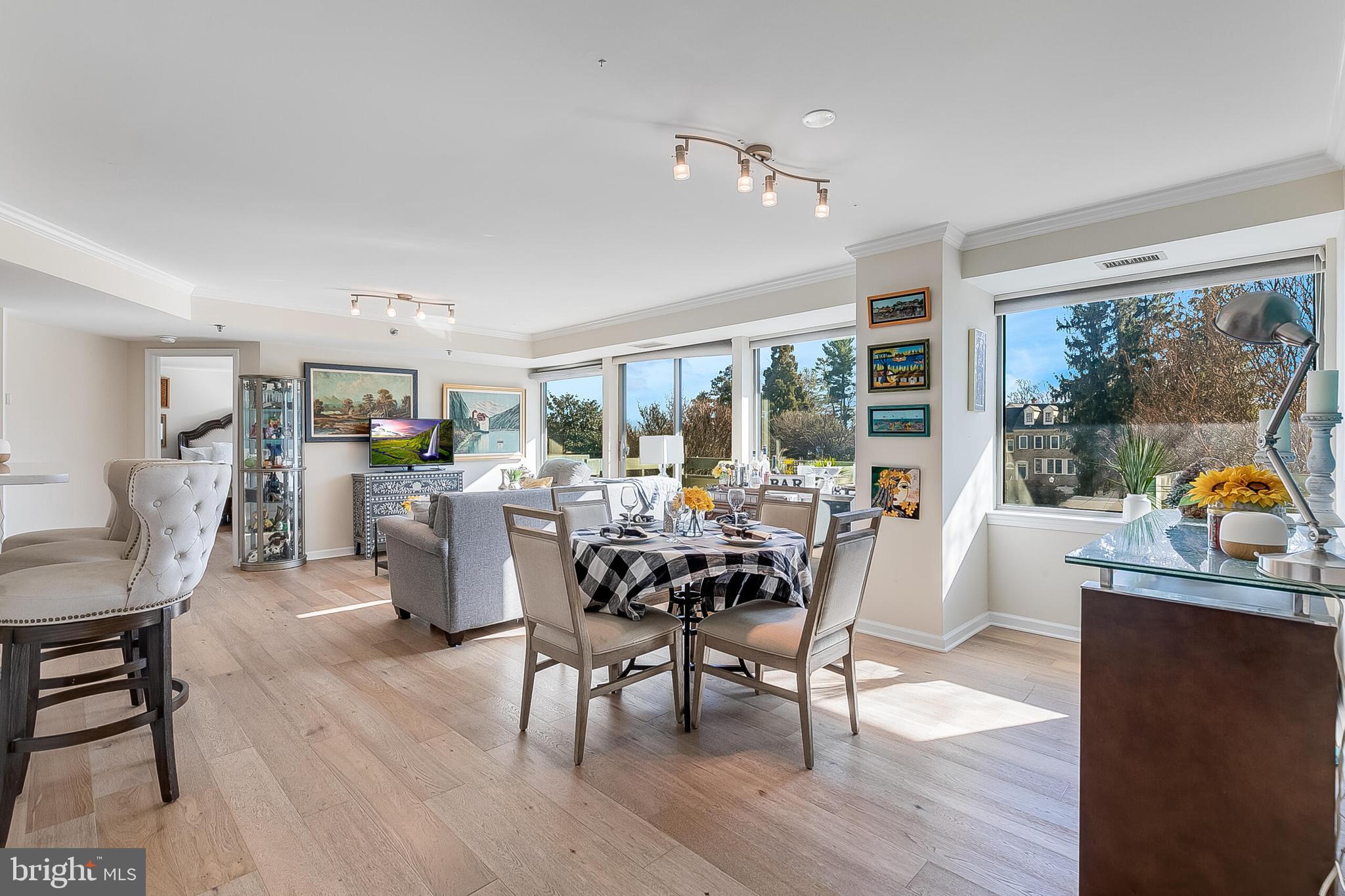 5450 Whitley Park Terrace, Unit 209 Bethesda, MD 20814 - Photo 14 of 29 a dining room with furniture a chandelier and wooden floor