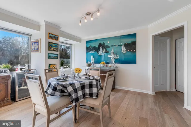 a dining room with wooden floor and a window