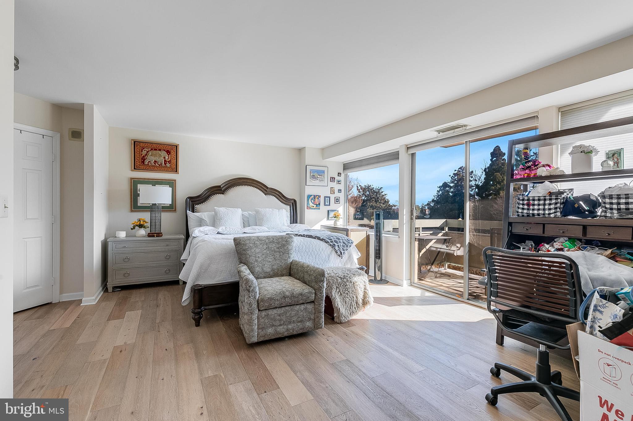 5450 Whitley Park Terrace, Unit 209 Bethesda, MD 20814 - Photo 17 of 29 a bedroom with furniture and a wooden floor