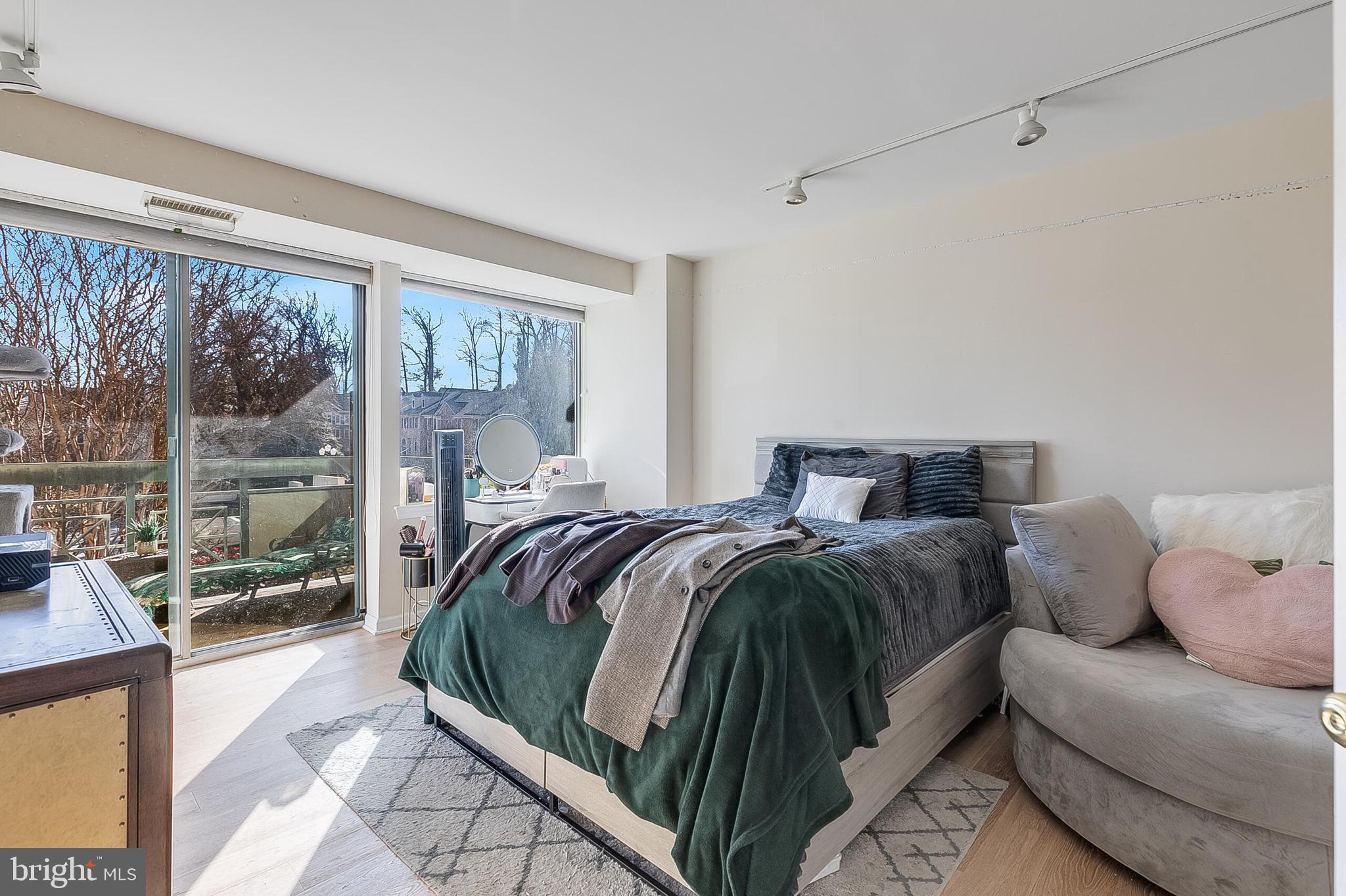 5450 Whitley Park Terrace, Unit 209 Bethesda, MD 20814 - Photo 21 of 29 a bed sitting in a bedroom next to a window