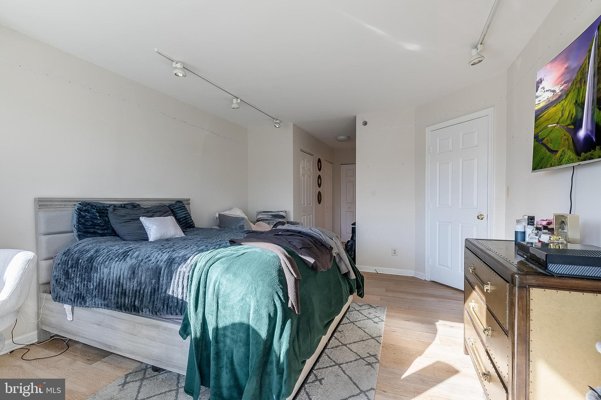 5450 Whitley Park Terrace, Unit 209 Bethesda, MD 20814 - Photo 23 of 29 a bedroom with a bed and a flat screen tv