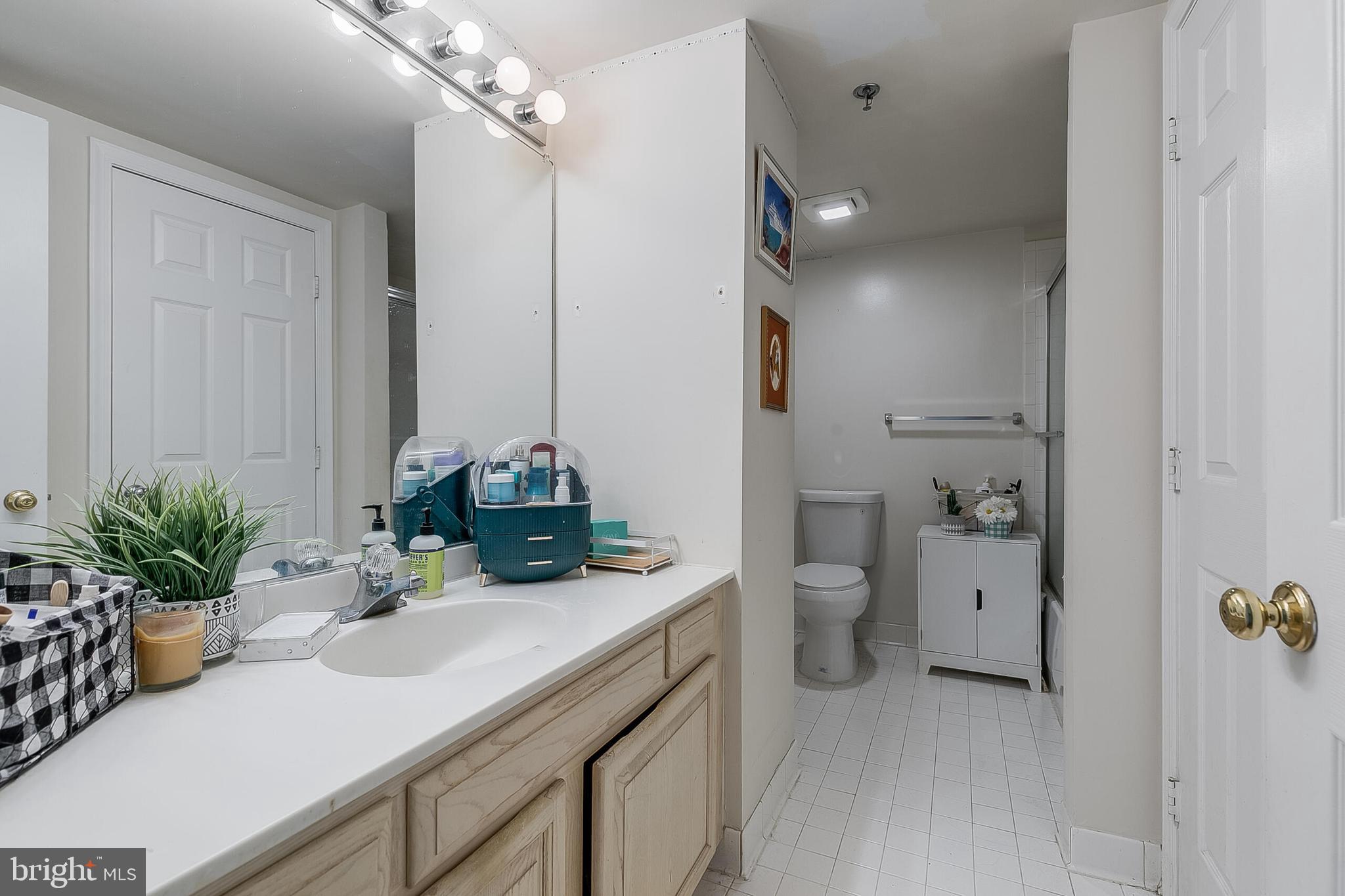 5450 Whitley Park Terrace, Unit 209 Bethesda, MD 20814 - Photo 24 of 29 a bathroom with a sink a toilet and shower