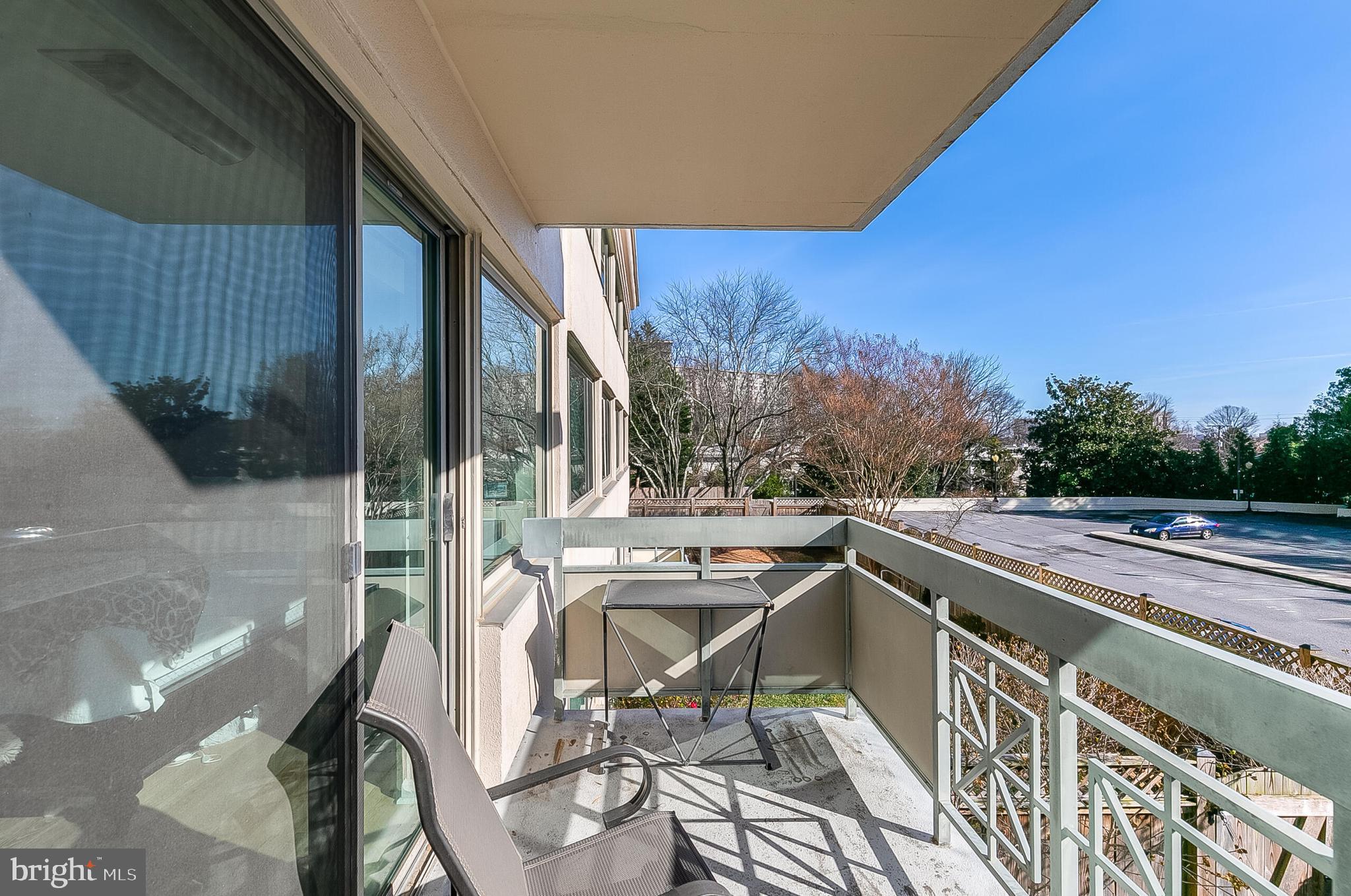 5450 Whitley Park Terrace, Unit 209 Bethesda, MD 20814 - Photo 25 of 29 a view of balcony with wooden floor and outdoor seating