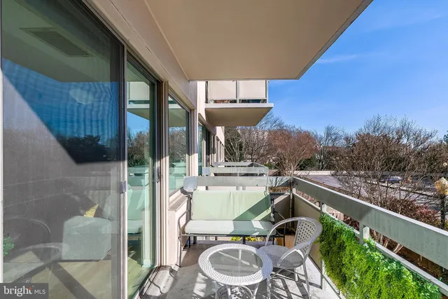 a view of a balcony with furniture and a rug
