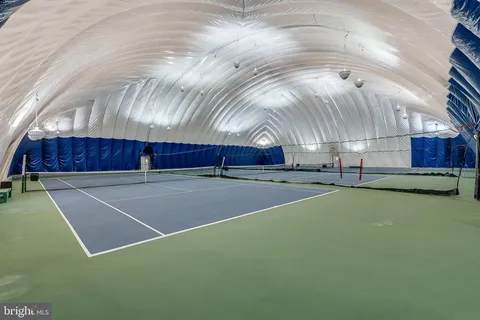 a dining room with furniture and a floor to ceiling window