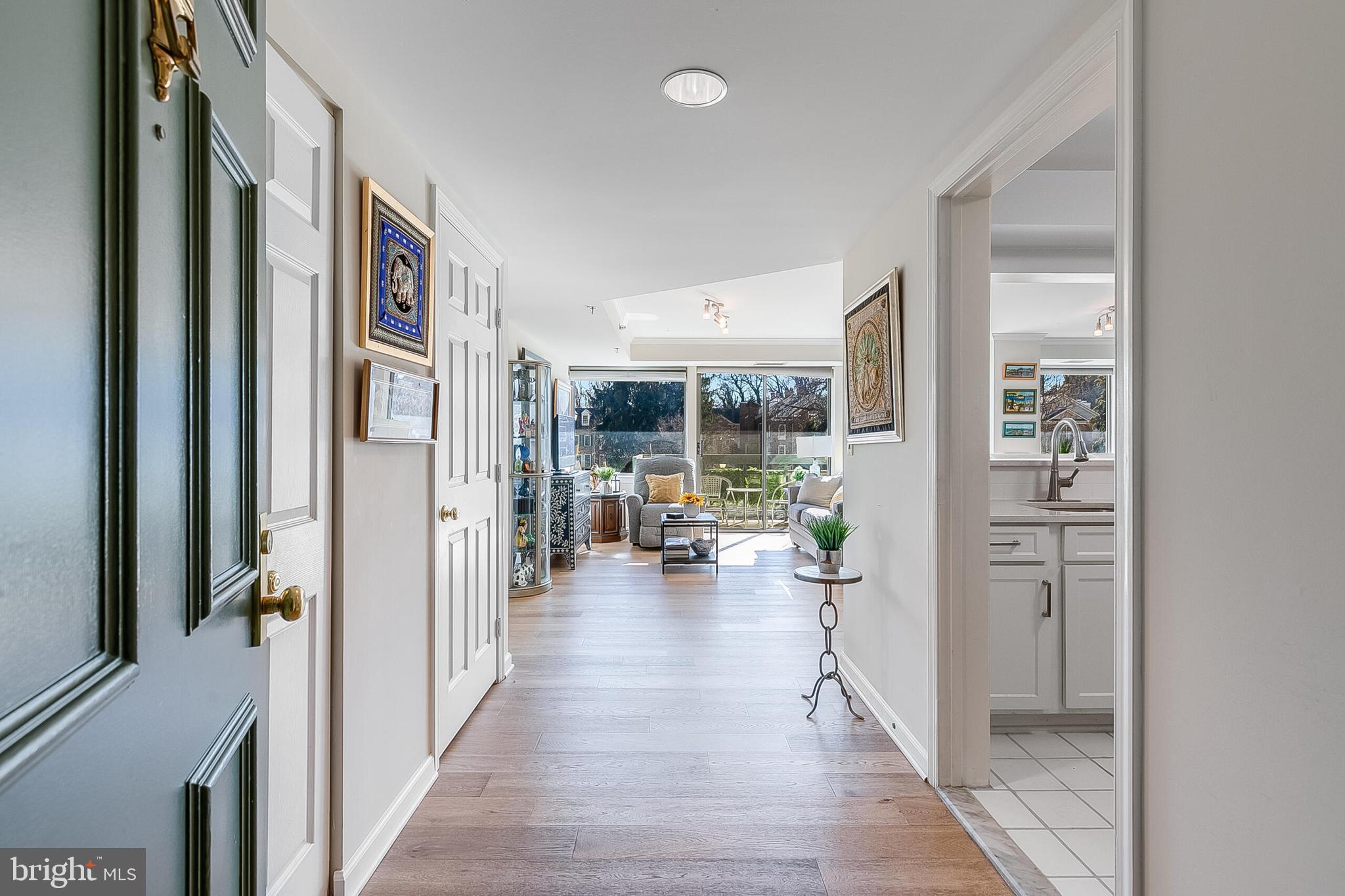 5450 Whitley Park Terrace, Unit 209 Bethesda, MD 20814 - Photo 10 of 29 a hall way with furniture and floor to ceiling window