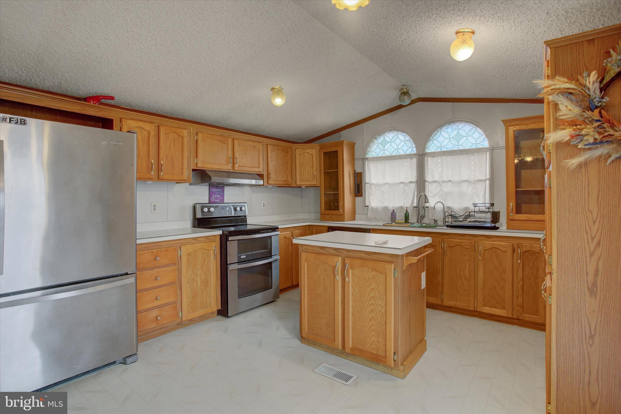 18103 Spring Run Road Dry Run, PA 17220 - Photo 9 of 33 a kitchen with stainless steel appliances granite countertop a refrigerator a stove a sink and a microwave