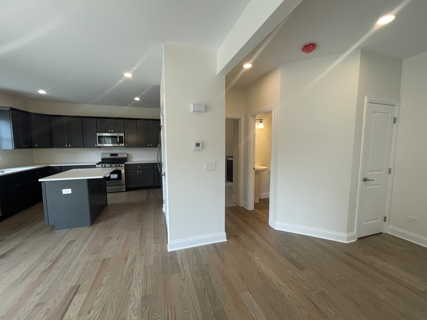 18800 Sara Road Mokena, IL 60448 - Photo 13 of 24 a kitchen with stainless steel appliances granite countertop a refrigerator a sink dishwasher and a stove with wooden floor