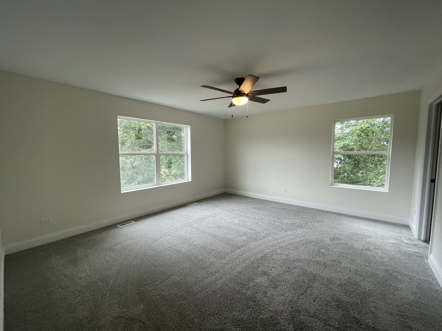 18800 Sara Road Mokena, IL 60448 - Photo 15 of 24 an empty room with windows and chandelier fan
