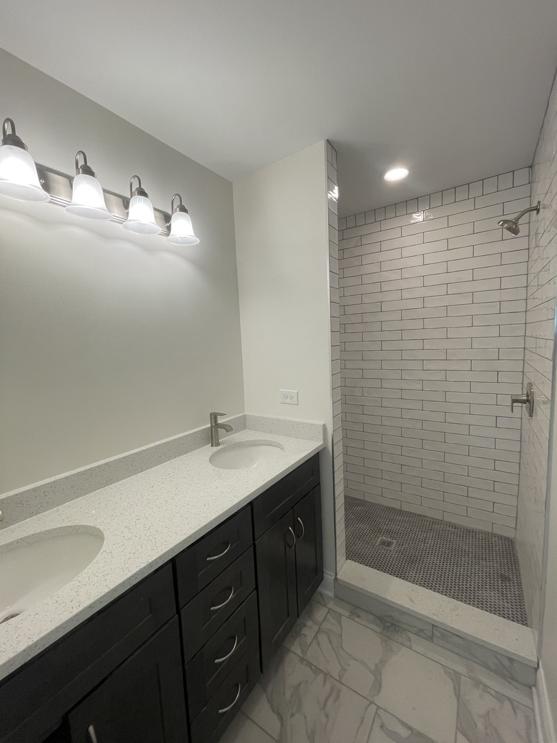 18800 Sara Road Mokena, IL 60448 - Photo 16 of 24 a bathroom with a sink a shower and a mirror