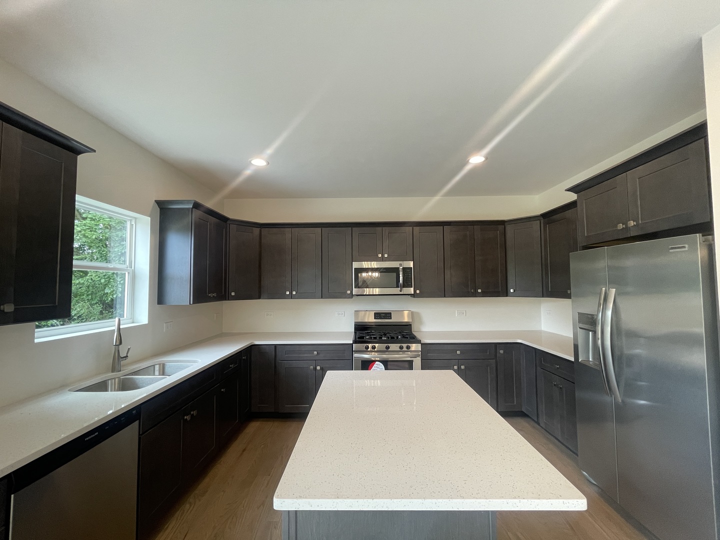 18800 Sara Road Mokena, IL 60448 - Photo 9 of 24 a kitchen with kitchen island a sink stove and refrigerator