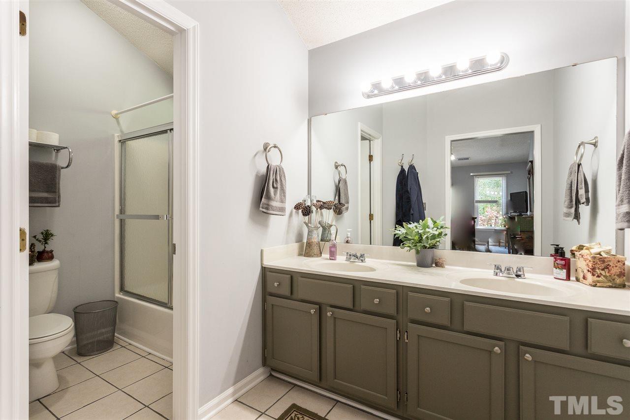 3549 Dechart Lane Raleigh, NC 27616 - Photo 22 of 26 a bathroom with a double vanity sink toilet and shower