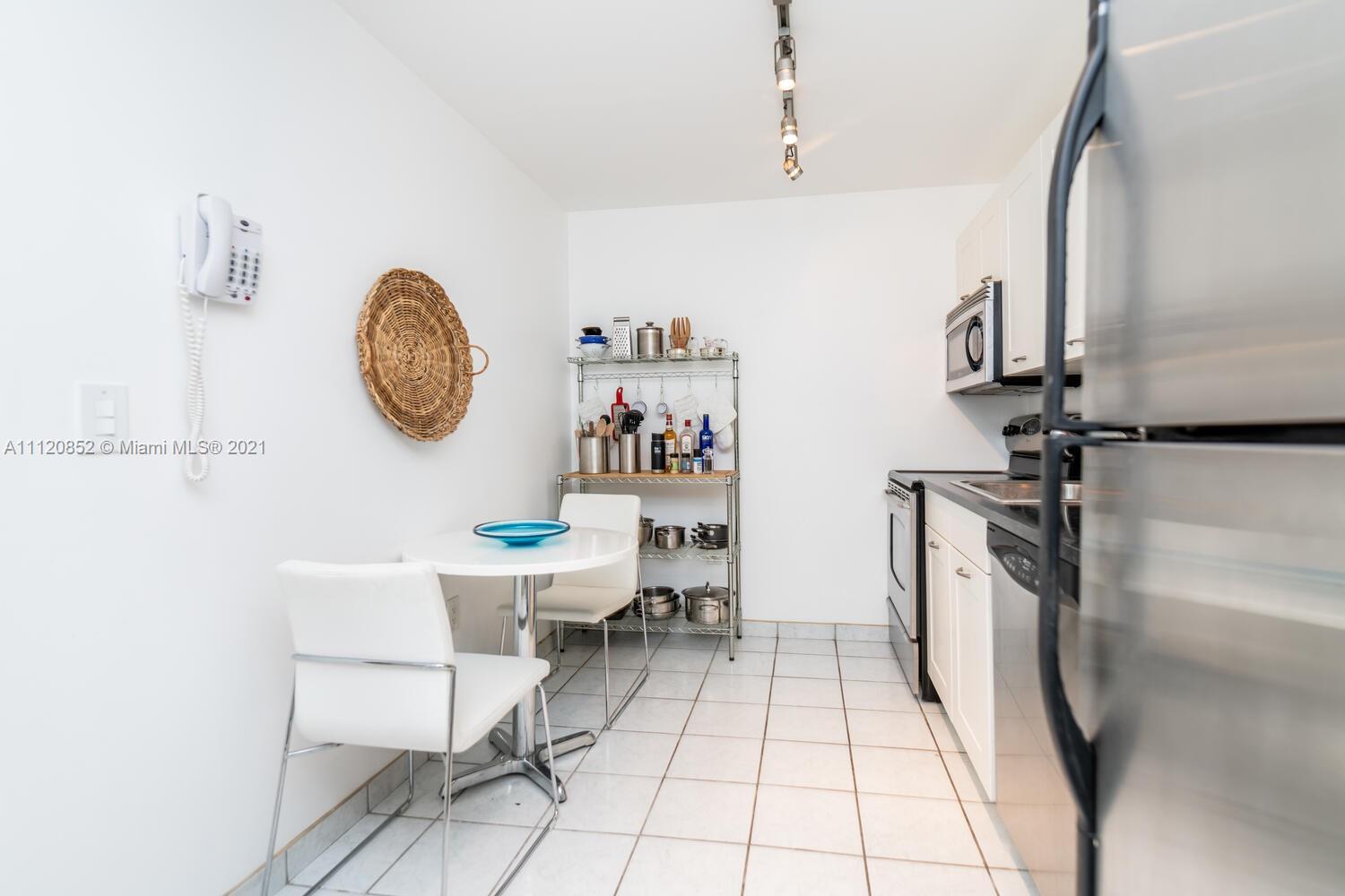 9273 Collins Avenue, Unit 801 Surfside, FL 33154 - Photo 12 of 47 a view of a kitchen with fridge and window